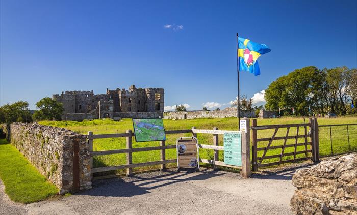 Image of the front of Carew Castle with the Pembrokeshire flag.